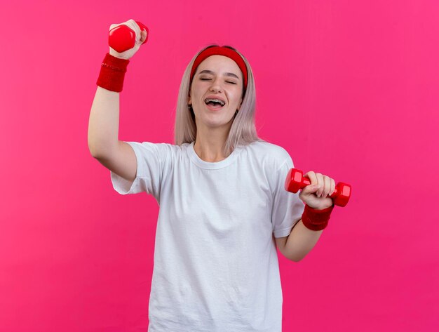 Joyful young caucasian sporty girl with braces wearing headband