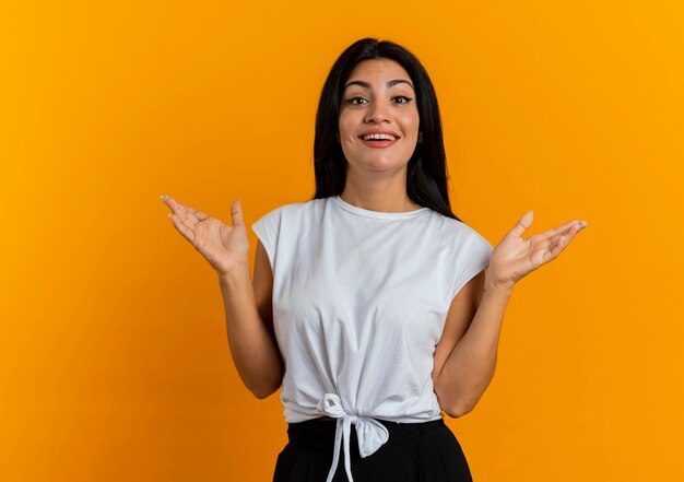 Joyful young caucasian woman stands holding hands open