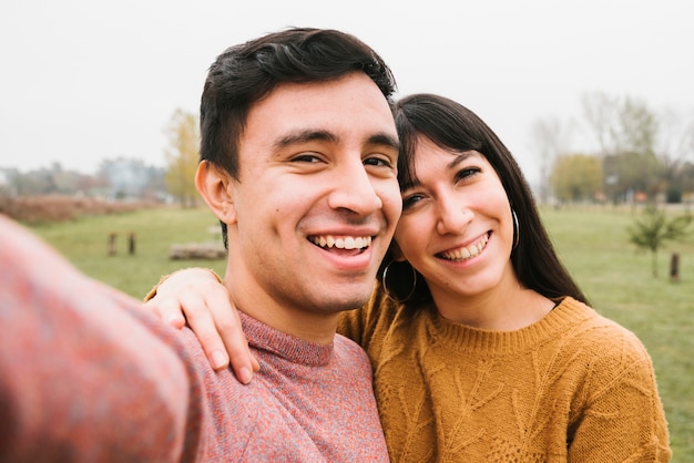 Joyful young couple taking selfie