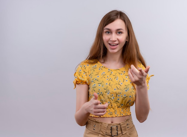 Joyful young girl doing you gesture  with copy space