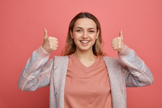 Joyful young girl showing thumbs up 