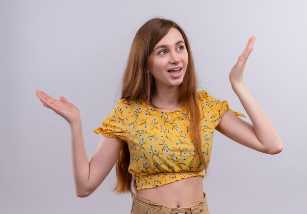 Joyful young girl with raised hands and looking at right side 