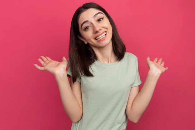 Joyful young pretty caucasian woman showing empty hands