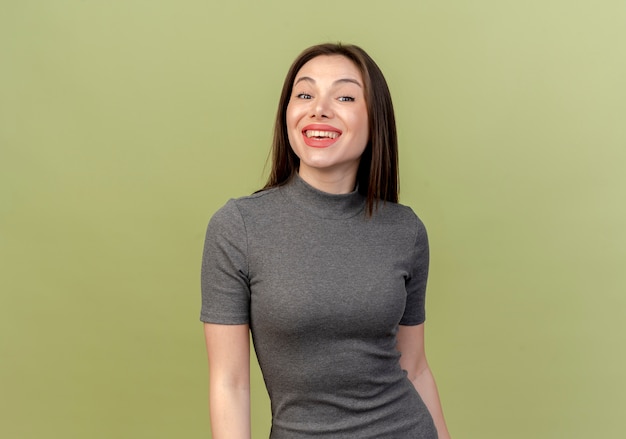 Joyful young pretty woman looking at camera isolated on olive green background with copy space