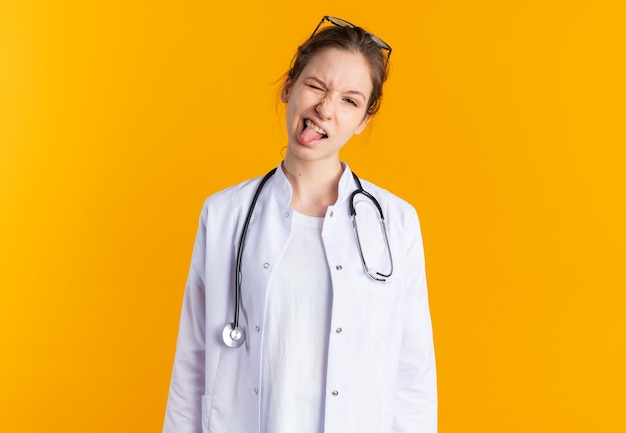 Free Photo | Smiling young doctor wearing medical gown wearing ...