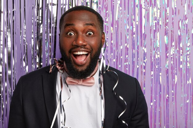 Joyous surprised Afro American man with toothy smile, white teeth