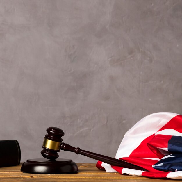 Judge gavel and united states flag with stucco background