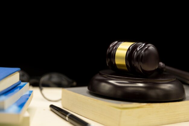 Judges gavel on book and wooden table. law and justice concept background.