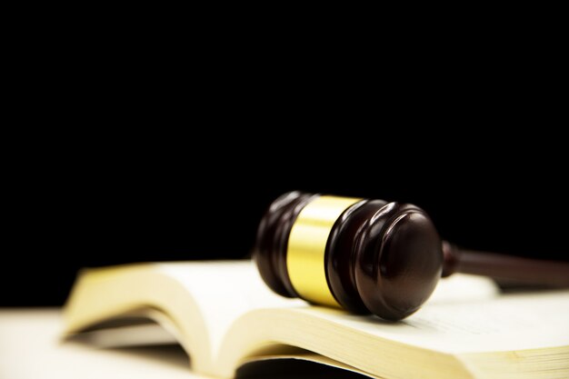 Judges gavel on book and wooden table. Law and justice concept background.