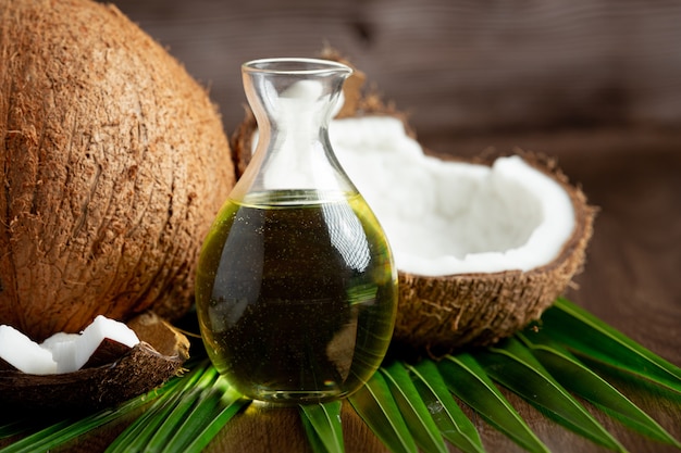 Free photo jug of coconut oil whit coconut put on dark background