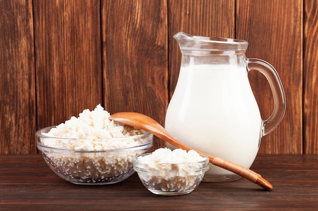 Free photo jug of milk and bowls with cheese