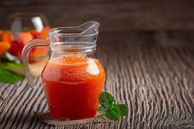 jug of papaya juice put on wooden floor