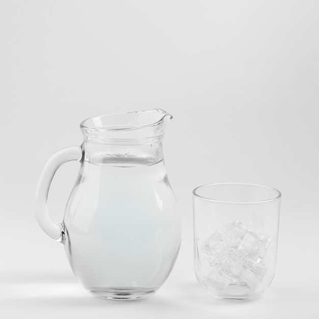 Free photo jug of water and glass filled with ice