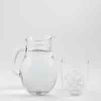 Free photo jug of water and glass filled with ice