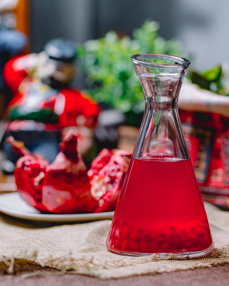 Free Photo jug with pomegranate sorbet with seeds on the bottom side view