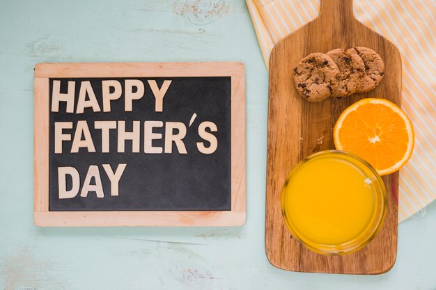 Juice and cookies near chalkboard with writing