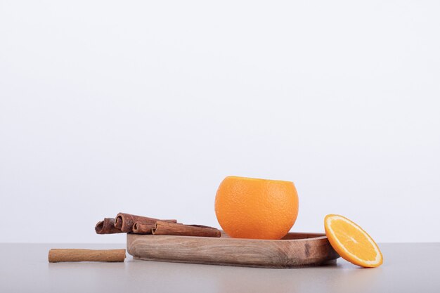 Juice inside of orange with cinnamon on white plate