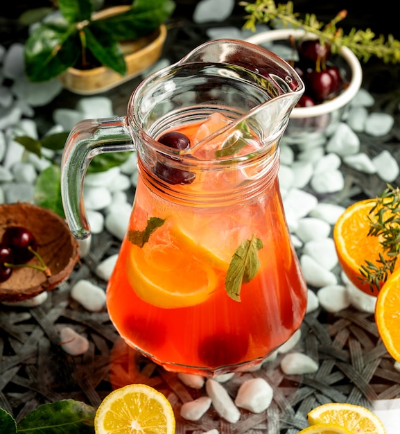 Juice jug with orange cherry and mint