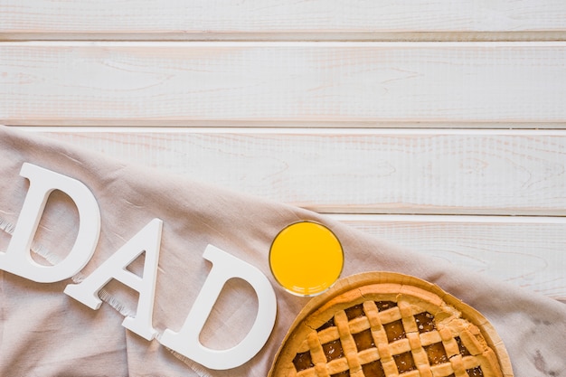 Foto gratuita succo e torta vicino alla scrittura di papà