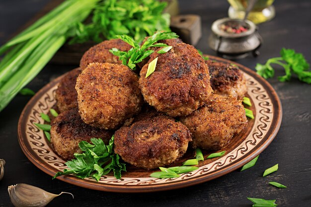 Juicy delicious meat cutlets on a dark table. Russian cuisine.