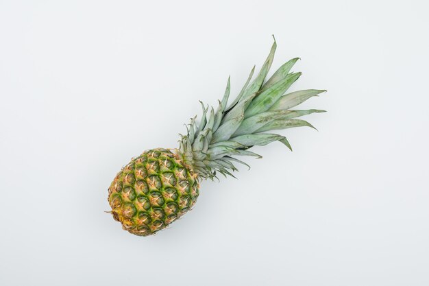 Juicy fresh pineapple on white gradient, flat lay.