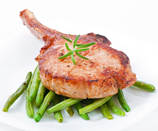 Juicy grilled pork fillet steak with green beans