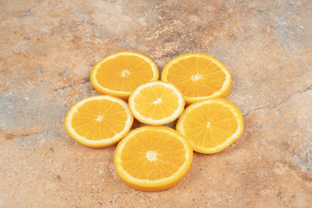 Succose fette d'arancia sulla superficie in marmo.