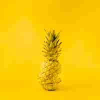 Free photo juicy pineapple on yellow background