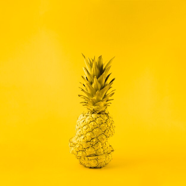 Juicy pineapple on yellow background