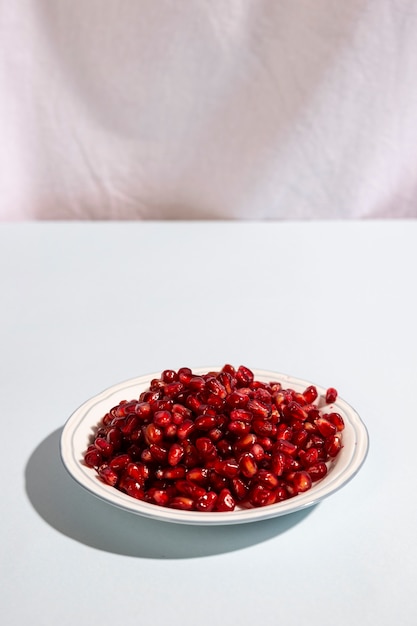 Juicy pomegranate seeds on plate