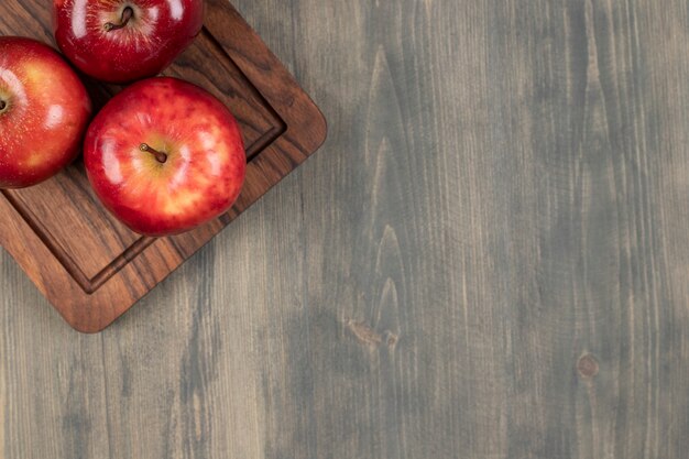 Juicy red apples on a wooden cutting board. High quality photo