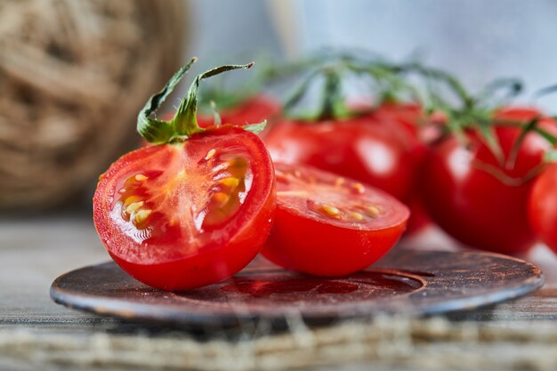 Juicy red tomato slices on ceramic plate.