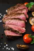 Free photo juicy steak medium rare beef with spices and grilled vegetables.