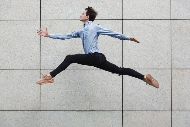 Jumping office man in the city, ballet dancer