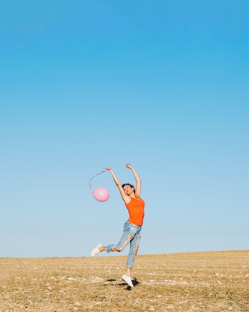 Free photo jumping woman with baloon