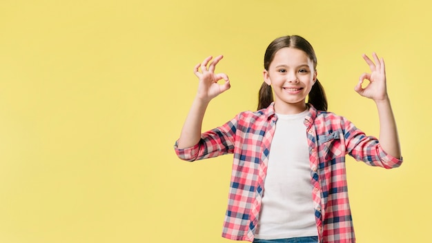 Junior raising hands with okay sign