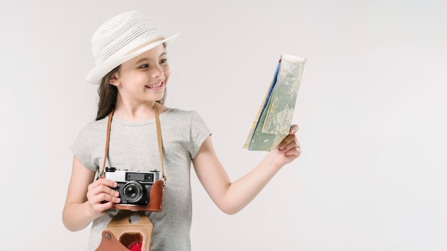 Junior traveler with map and camera