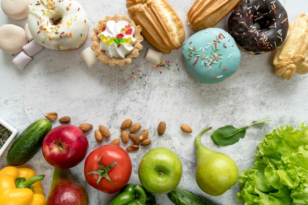 Junk food and healthy food on old concrete background