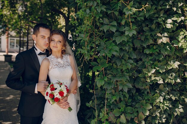 Just-married couple hugging outdoors