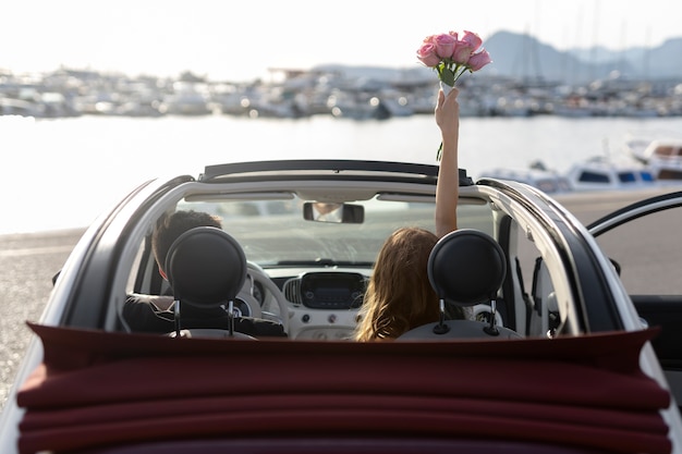 Free photo just married couple inside little car