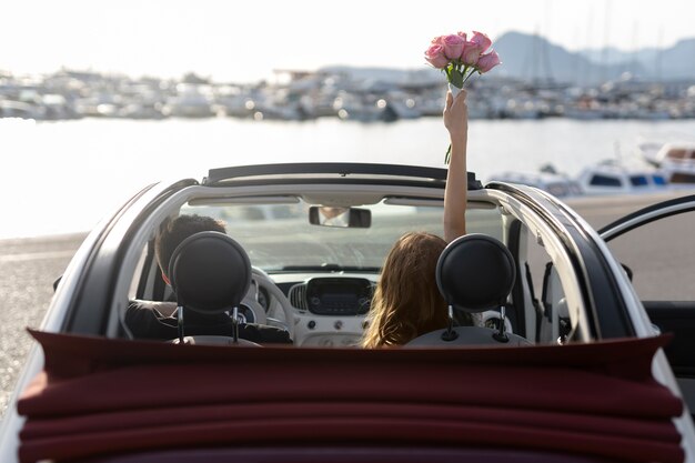 Just married couple inside little car