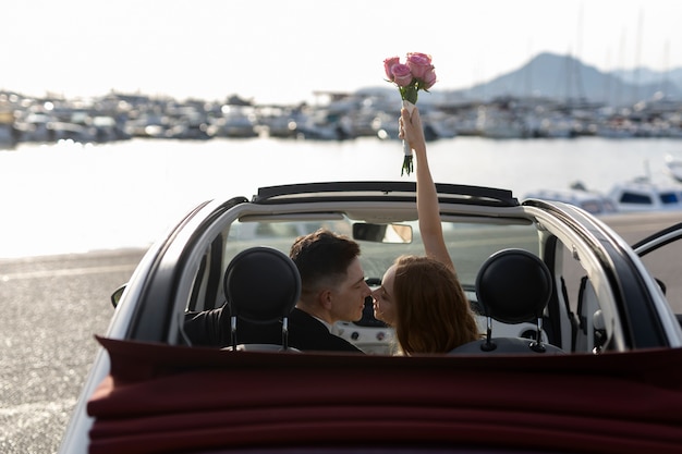 Free photo just married couple inside little car