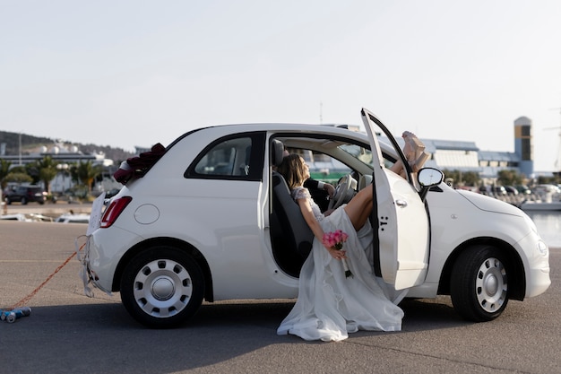 Free photo just married couple inside little car