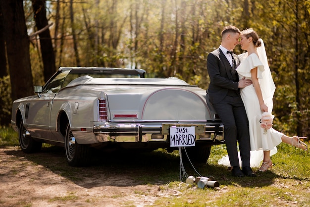 Just married couple with their car