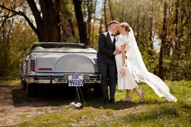 Just married couple with their car