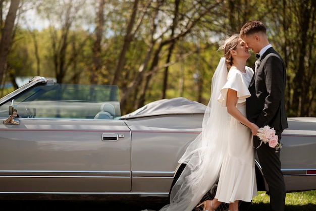 Free photo just married couple with their car