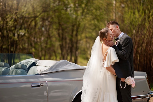 Free photo just married couple with their car