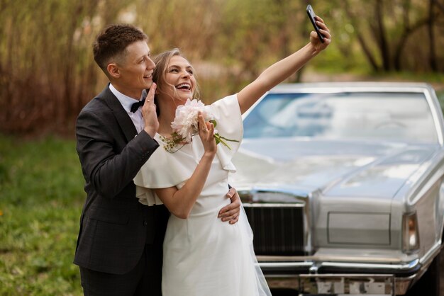 Just married couple with their car