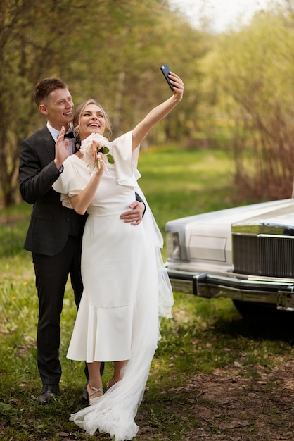 Just married couple with their car