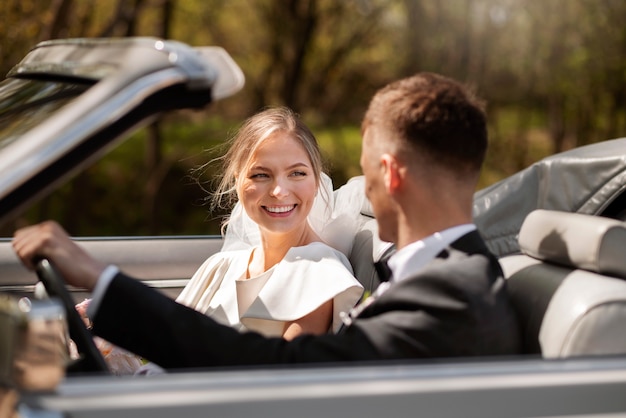 Just married couple with their car